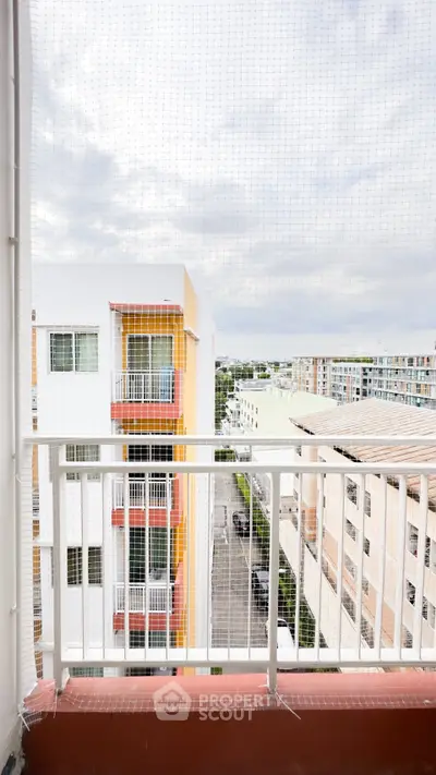 Stunning balcony view overlooking modern apartment buildings and cityscape, perfect for urban living.