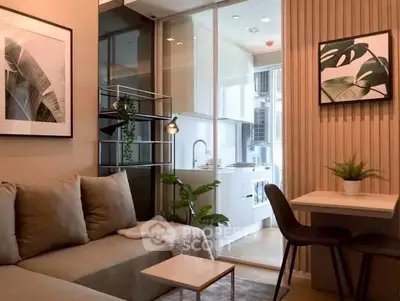 Modern living room with cozy sofa, stylish decor, and open kitchen layout in a chic apartment.