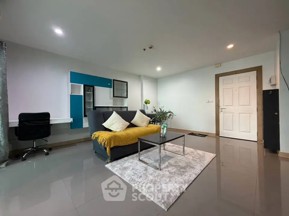 Spacious modern living room with sleek design and cozy seating area.
