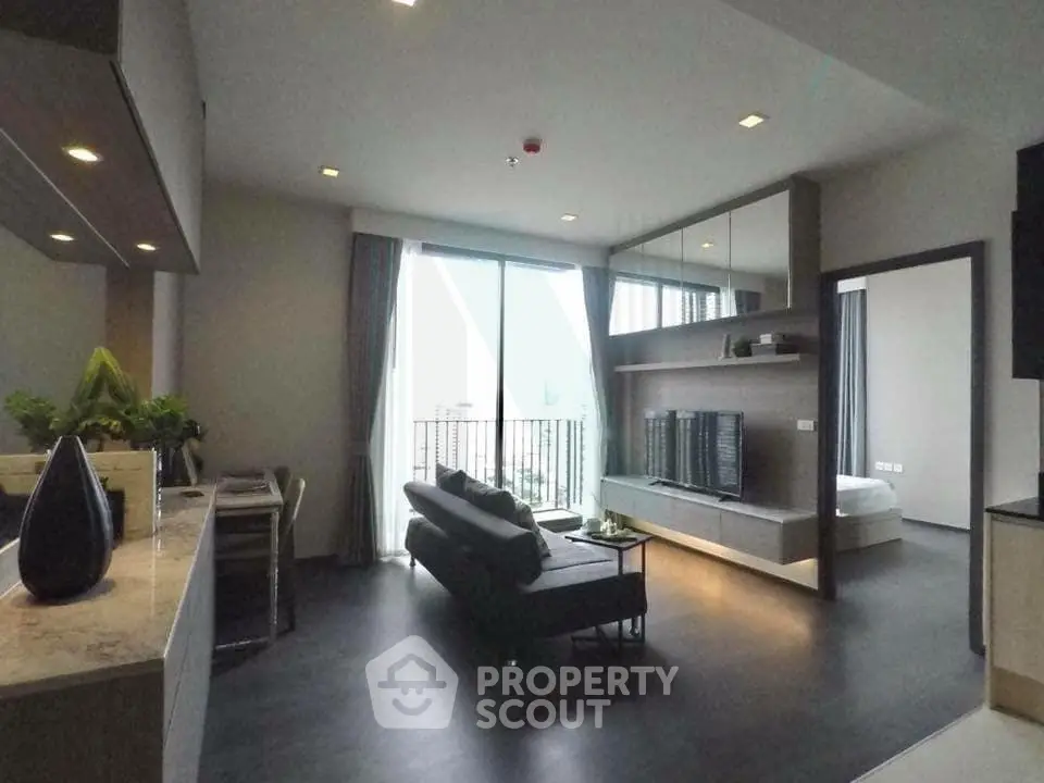 Modern living room with sleek design and large windows offering city views
