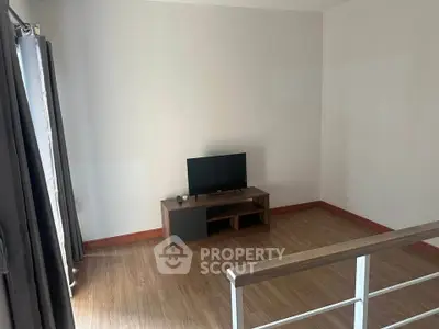 Modern living room with sleek TV stand and wooden flooring, perfect for cozy entertainment.