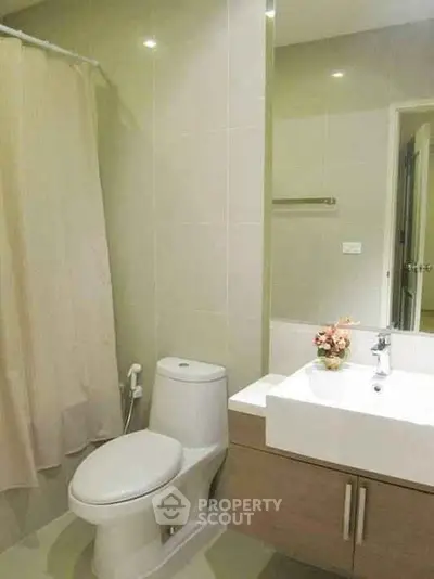 Modern bathroom with sleek fixtures and elegant design, featuring a stylish sink and toilet.