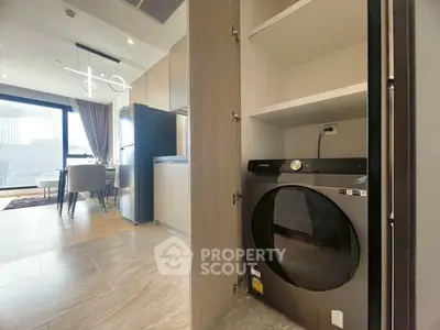 Modern apartment with integrated laundry and dining area, featuring sleek design and natural light.