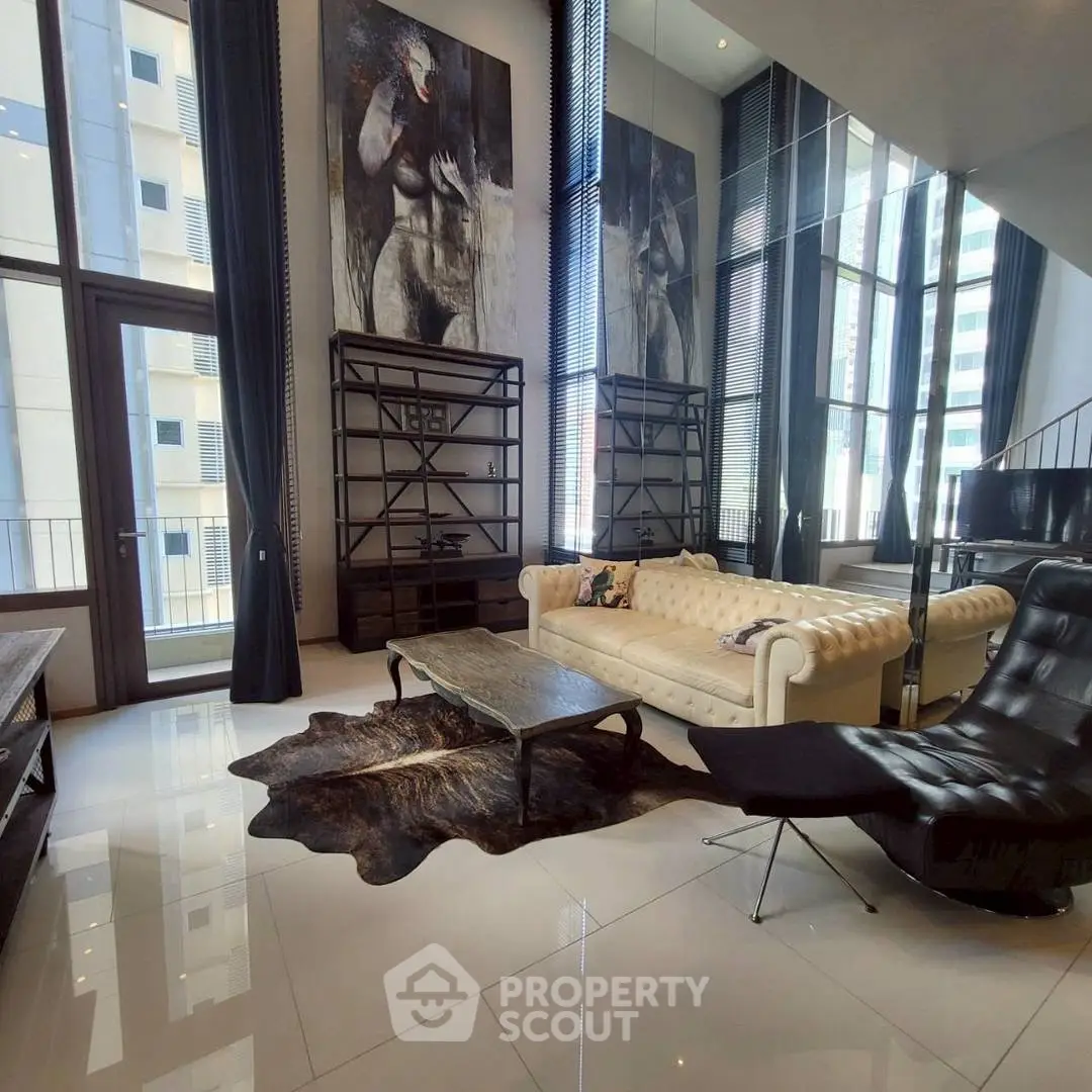 Luxurious modern living room with high ceilings, elegant furniture, and floor-to-ceiling windows.