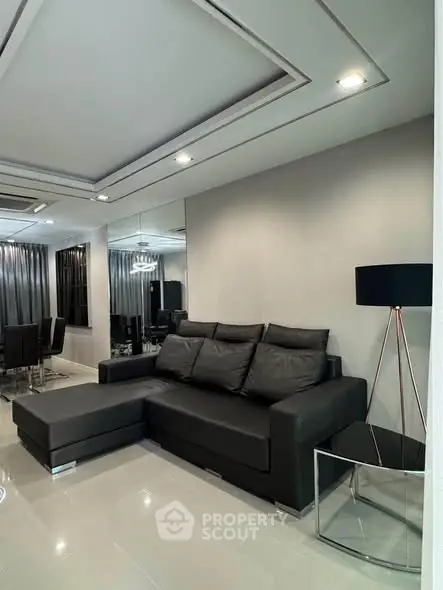 Modern living room with sleek black sofa and elegant decor