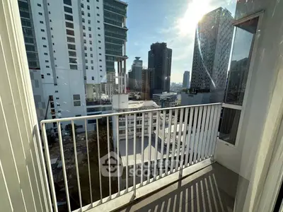 Modern city view from a high-rise balcony with sleek railing design.