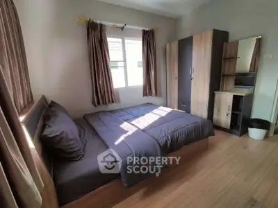Cozy bedroom with modern furnishings and natural light, perfect for relaxation and comfort.