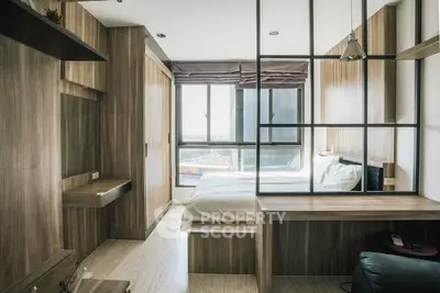 Modern bedroom with wooden accents and large window offering natural light.