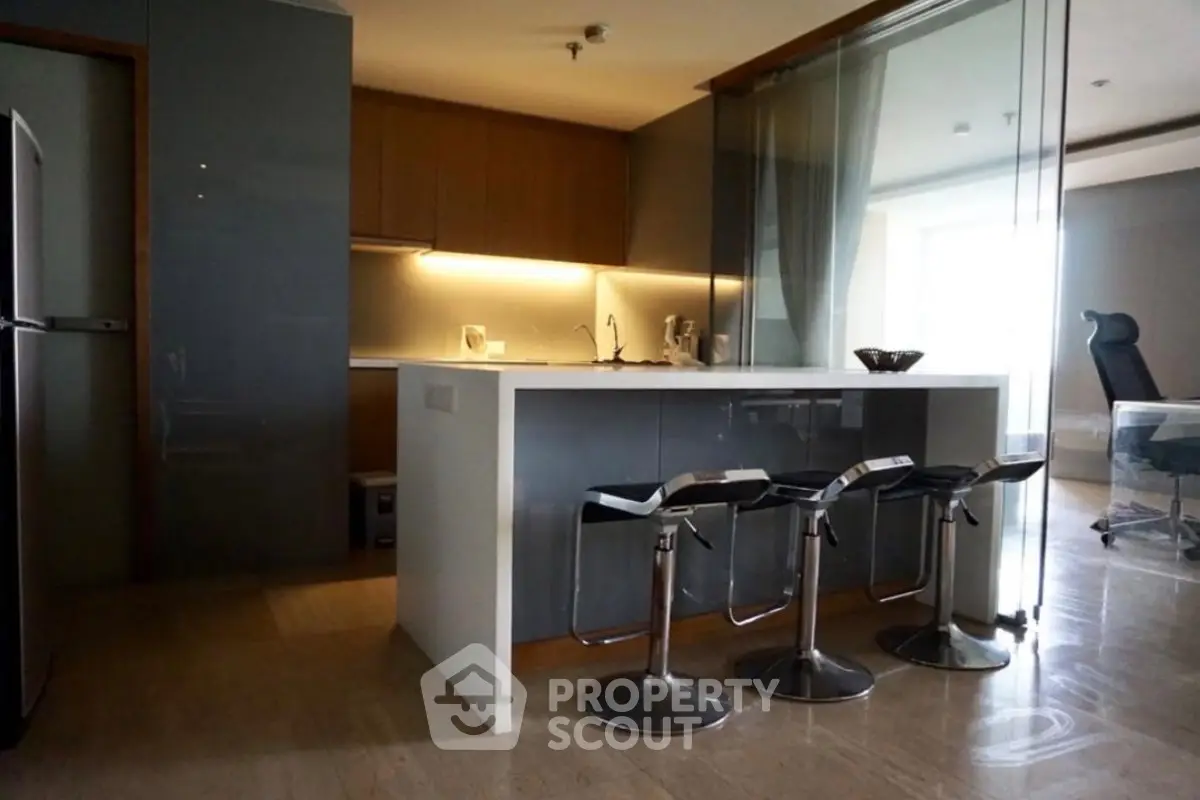 Modern kitchen with sleek design and breakfast bar in luxury apartment