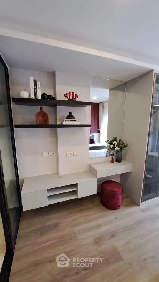 Modern living room with stylish shelving and cozy decor in a contemporary apartment.