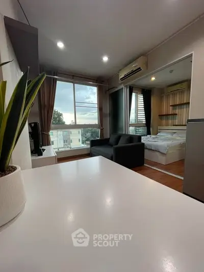 Modern studio apartment with open layout and large window view