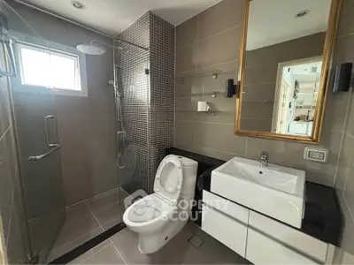 Modern bathroom with sleek fixtures and glass shower enclosure