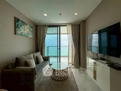 Luxurious living room with ocean view, modern decor, and elegant furnishings.