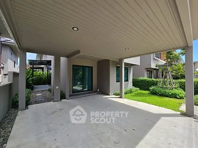 Spacious modern home with covered patio and lush garden view