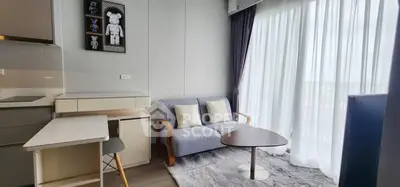 Modern living room with cozy sofa and natural light from large window