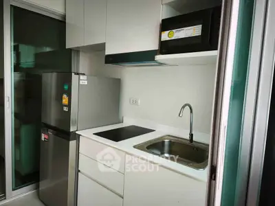 Modern compact kitchen with sleek appliances and minimalist design