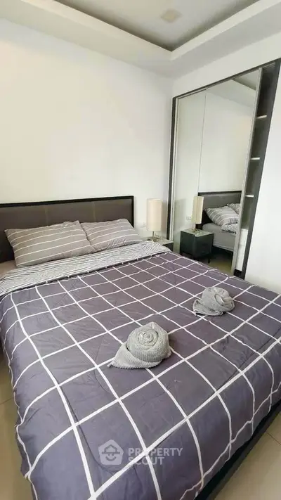 Modern bedroom with stylish decor and large mirror closet