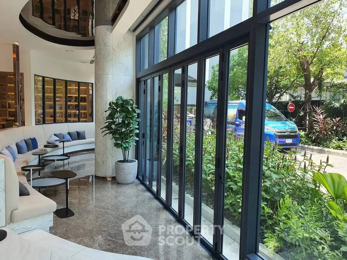 Luxurious modern living room with floor-to-ceiling windows and garden view