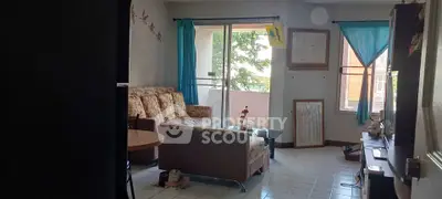 Cozy living room with natural light and balcony access