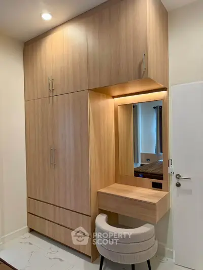 Modern bedroom with built-in wooden wardrobe and stylish vanity area