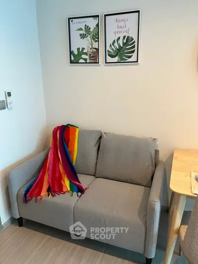 Cozy living room with modern gray sofa and vibrant decor accents