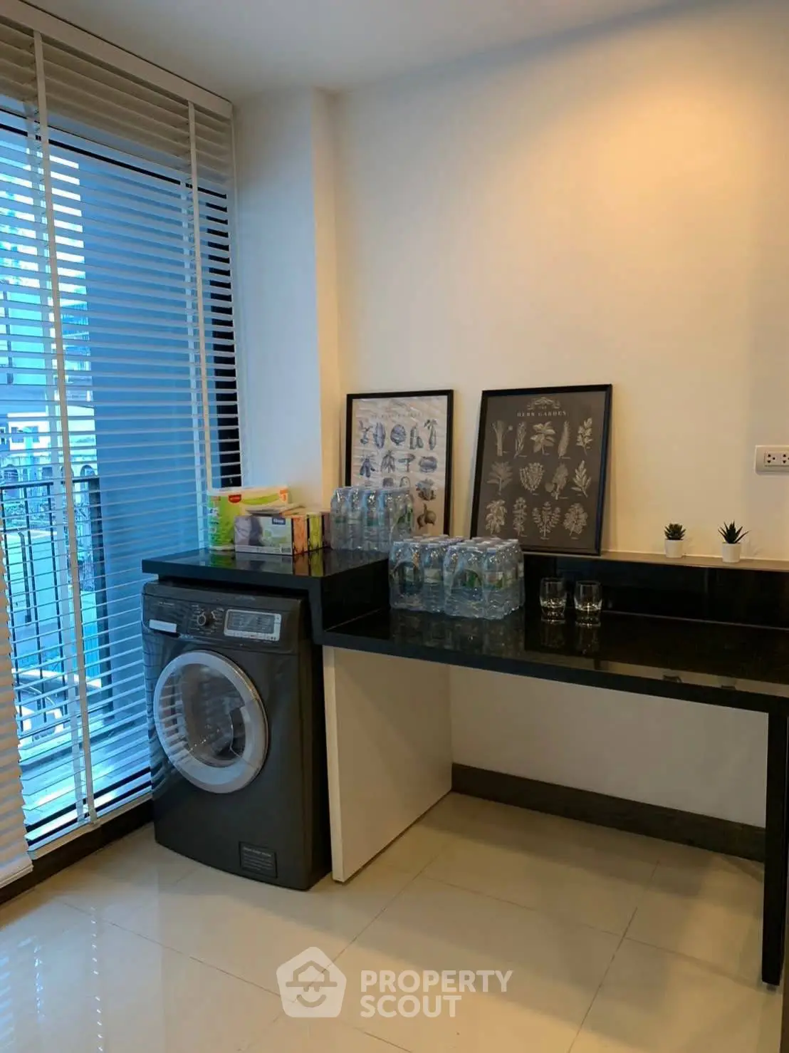 Modern laundry area with washing machine and stylish decor in a bright apartment.