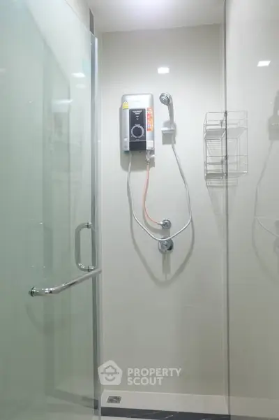 Modern bathroom with glass shower enclosure and electric water heater