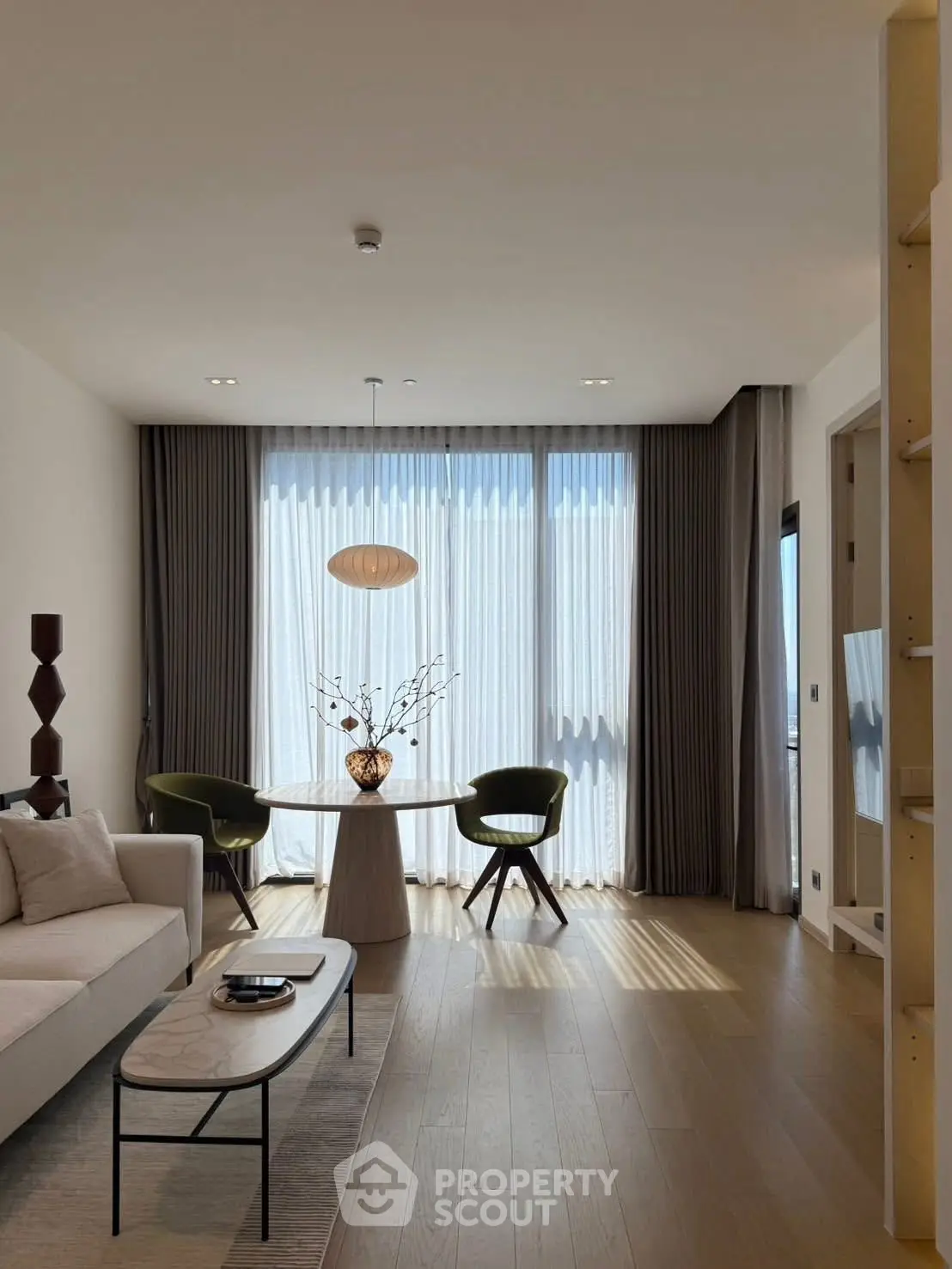 Modern living room with stylish furniture and large windows offering natural light.