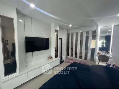 Luxurious modern bedroom with sleek design and built-in TV unit