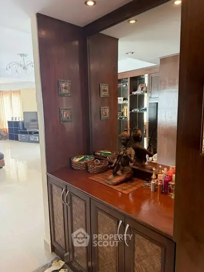 Elegant living room with wooden cabinetry and decorative accents