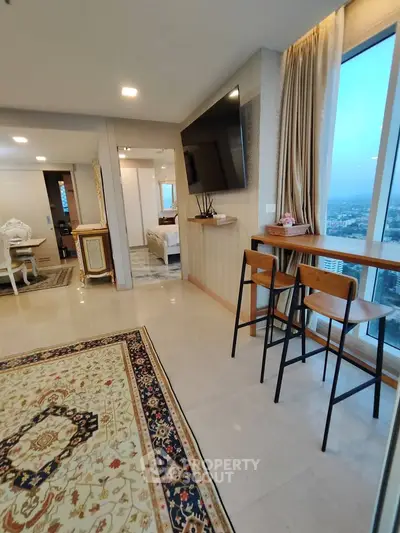 Luxurious high-rise apartment with stunning city views, elegant decor, and spacious open layout.