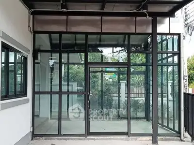 Modern glass entrance with sleek design and natural light