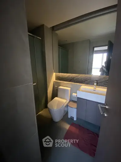 Modern bathroom with sleek design and contemporary fixtures in a stylish apartment.