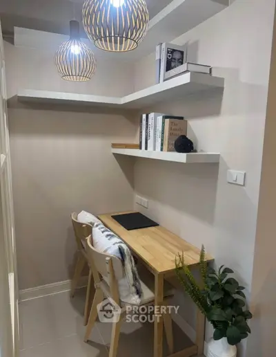 Cozy study nook with wooden desk, modern lighting, and stylish decor