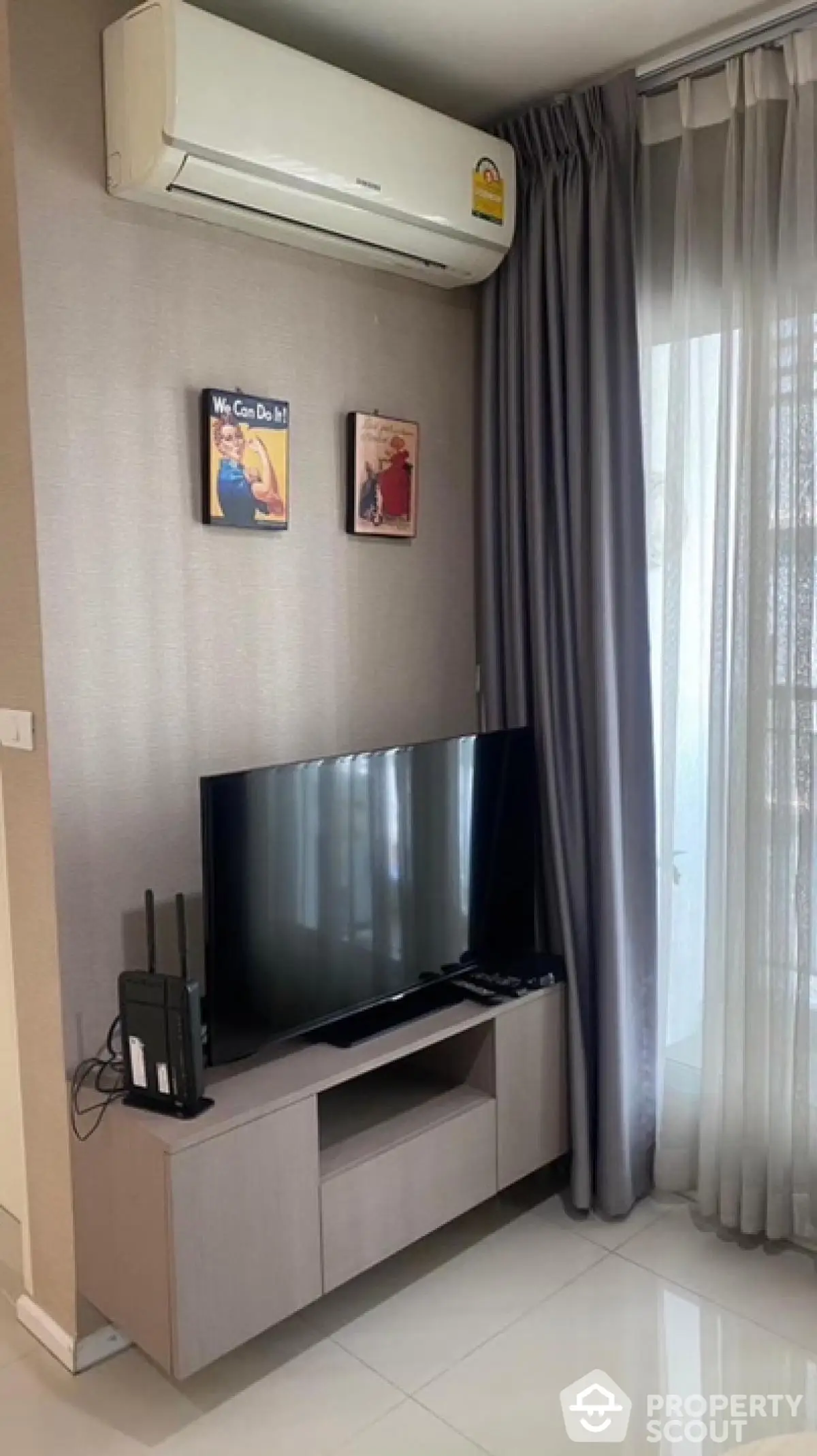 Modern living room with sleek TV unit and air conditioning