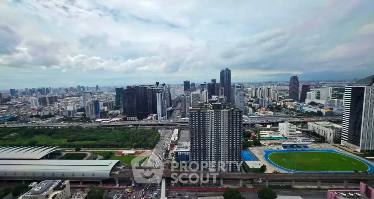 Stunning cityscape view showcasing modern skyscrapers and urban landscape with lush greenery and sports facilities.