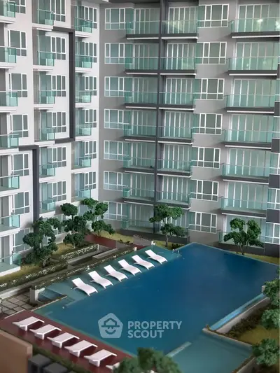 Luxurious condominium with modern pool and lush greenery, perfect for urban living.