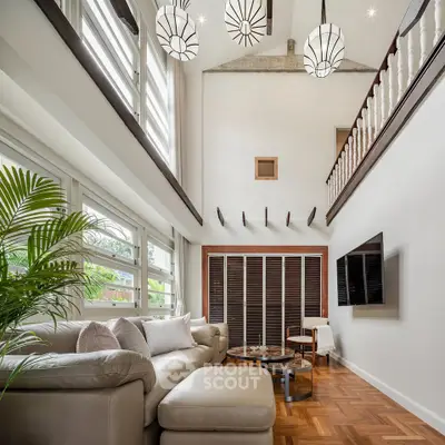 Luxurious living room with high ceilings, modern decor, and elegant lighting.