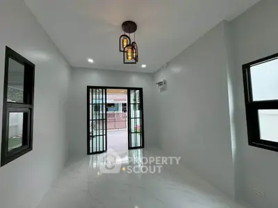 Modern minimalist room with large windows and stylish lighting, perfect for a bright and airy living space.