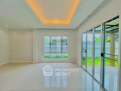 Spacious modern living room with large windows and garden view