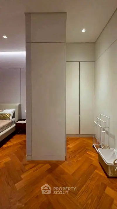 Modern bedroom with elegant wooden flooring and minimalist design