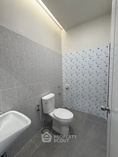 Modern bathroom with sleek tiles and contemporary fixtures, ideal for a stylish home upgrade.