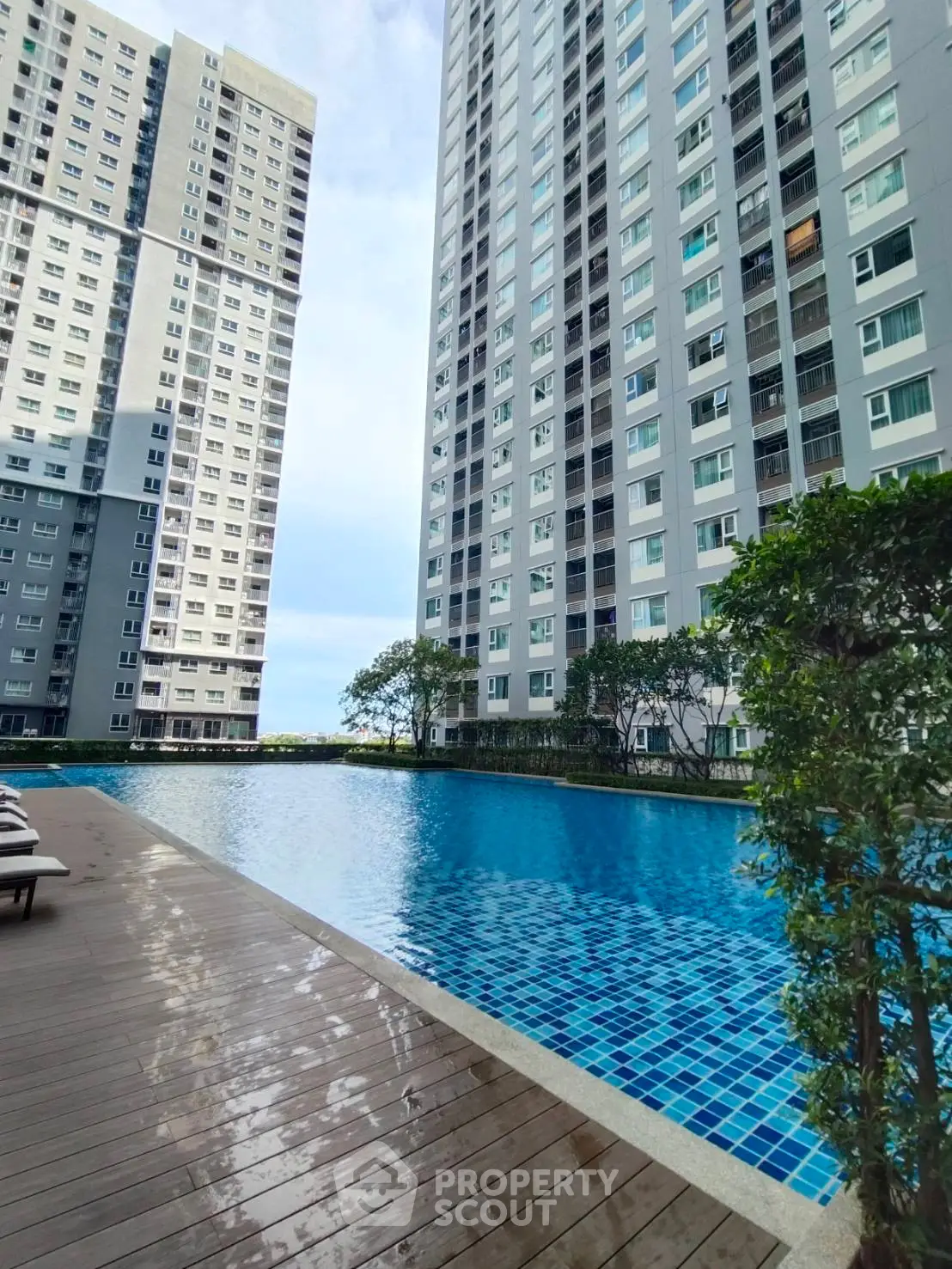 Luxurious high-rise apartment complex with stunning pool and modern amenities.