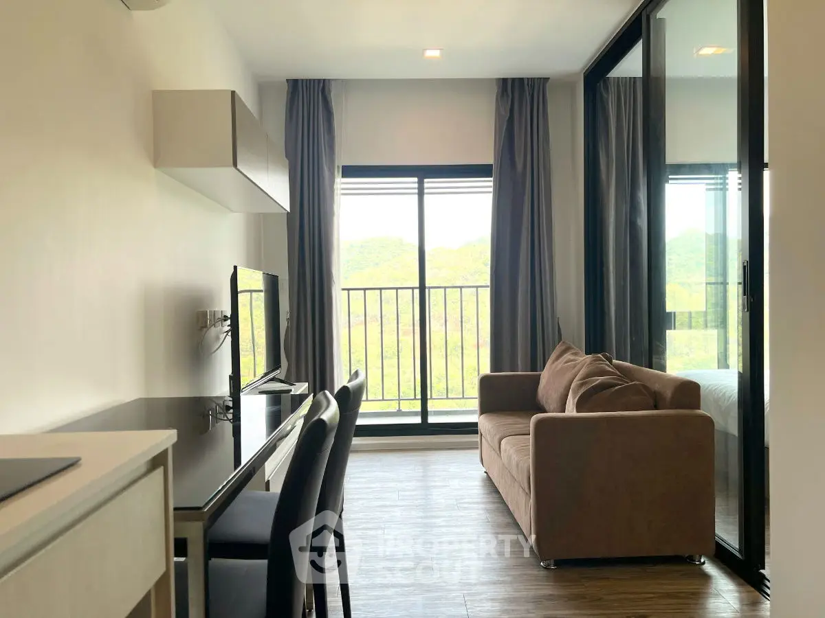 Modern living room with balcony view and sleek furniture in a stylish apartment.