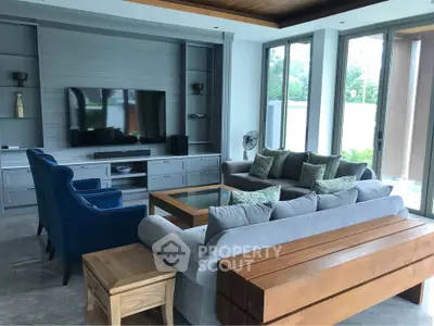 Spacious modern living room with large windows and stylish furniture