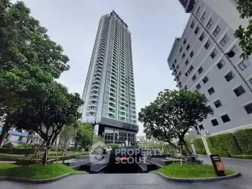 Stunning high-rise building with lush greenery and modern architecture.