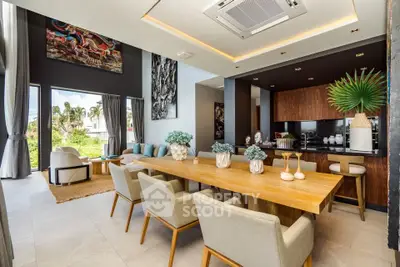 Luxurious open-plan living and dining area with modern decor and garden view.