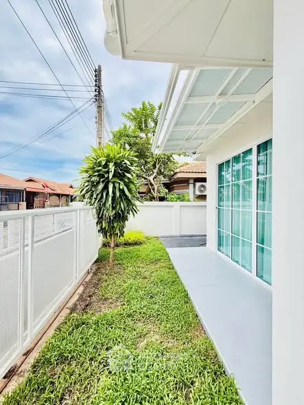 Charming garden view of modern home with lush greenery and sleek design.