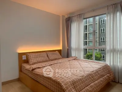 Cozy bedroom with large window and modern decor in urban apartment