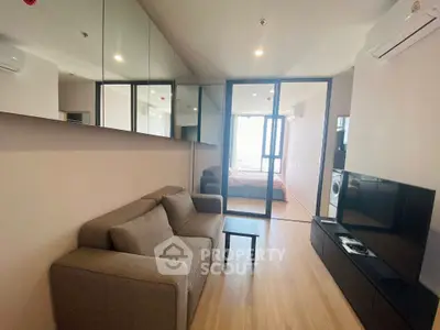 Modern living room with mirrored wall and cozy sofa in stylish apartment